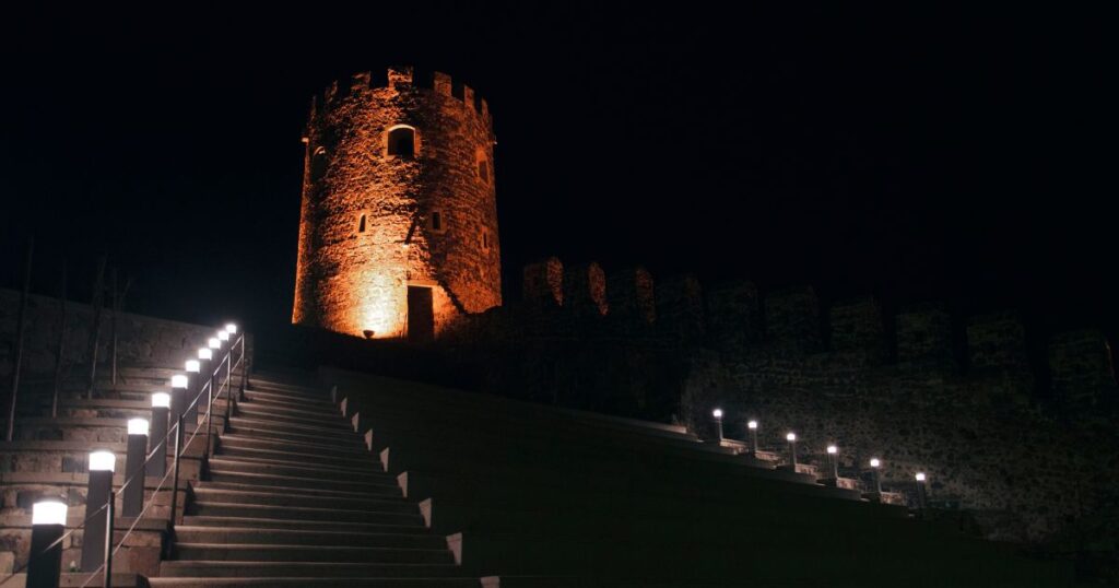 Aerial night view of Delhi’s illuminated monuments and bustling night markets.